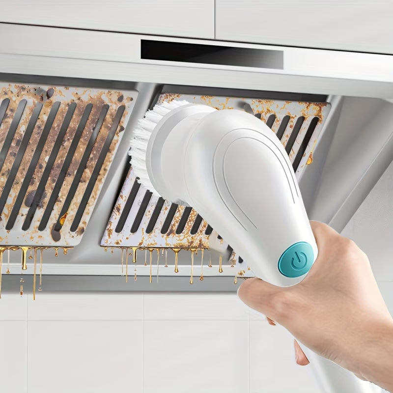 Hand holding a white electric cleaning brush with a blue button over a rusty kitchen exhaust hood.